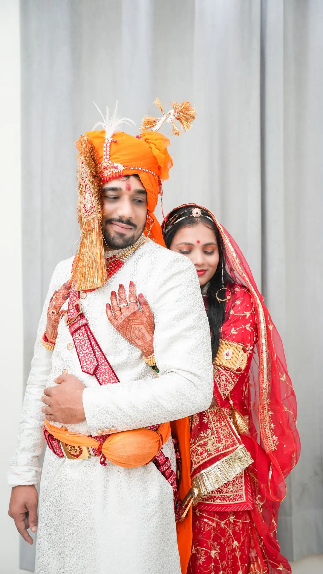 Bride in traditional red bridal outfit captured by Bright Luxe Studio.