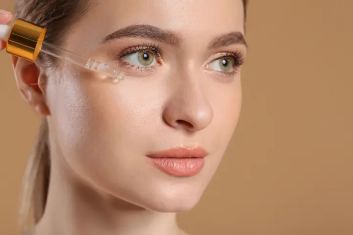 Glowing skin woman after facial treatment at Bright Luxe Salon &amp; Studio showcasing healthy skincare results.