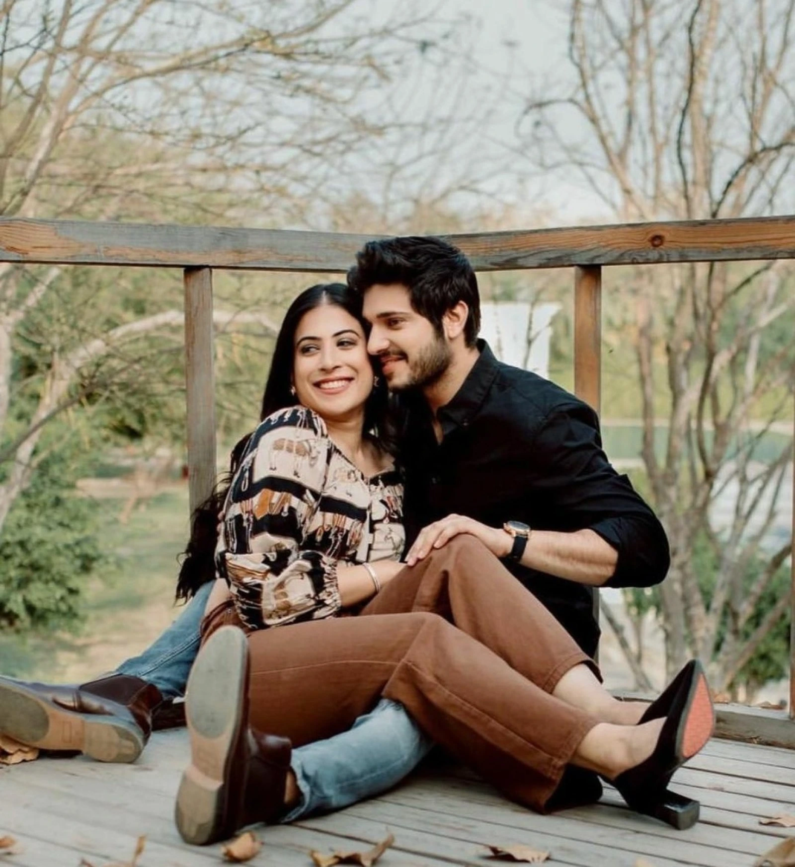 Relaxed outdoor pre-wedding couple sitting shot by Bright Luxe Salon &amp; Studio, Mahendergarh